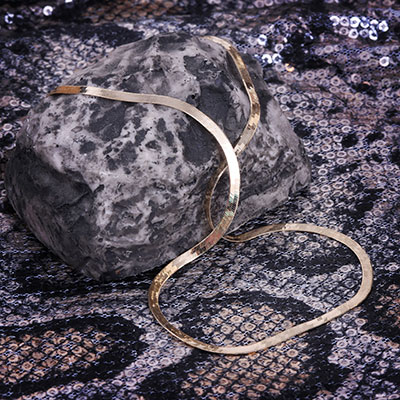 herringbone liquid gold necklace on snake skin and stone